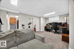 Finished Basement Recreation Space featuring plush seating, carpeted flooring, recessed ceiling lighting, and dedicated zones for entertainment and workspace - 