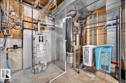 Dedicated utility space featuring a water heater, furnace, and exposed structural elements - 