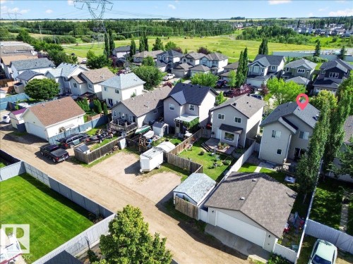 Aerial view of a residential neighborhood showcasing this property's generous lot with mature landscaping, including established trees and manicured lawn - 887 Oakland Boulevard, Devon, AB - Outdoor With View