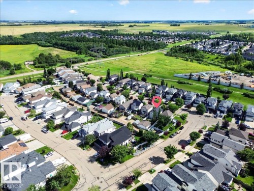 Aerial view of a well-planned residential community featuring organized street layouts, diverse architectural styles, and generous lot sizes - 887 Oakland Boulevard, Devon, AB - Outdoor With View