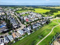 Established neighborhood with a residential street, ample green space, and extensive tree coverage - 