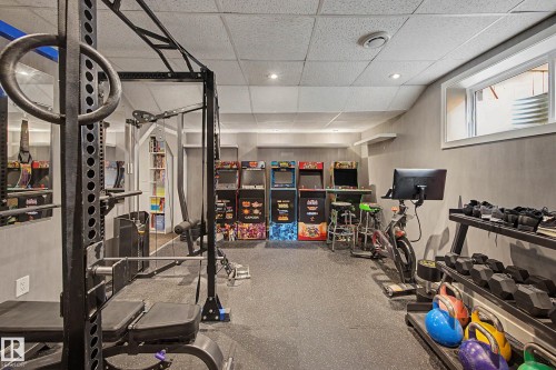 Spacious lower-level room featuring durable rubber flooring, recessed lighting, and a window providing natural light - 21 Nash Close, St. Albert, AB - Indoor Photo Showing Gym Room