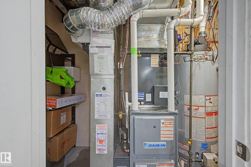 Utility closet featuring a water heater, furnace, and exposed ductwork - 21 Nash Close, St. Albert, AB - Indoor Photo Showing Basement