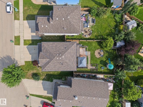 Expansive property featuring a large private backyard with mature trees, a dedicated deck space, and paved driveway - 21 Nash Close, St. Albert, AB - Outdoor
