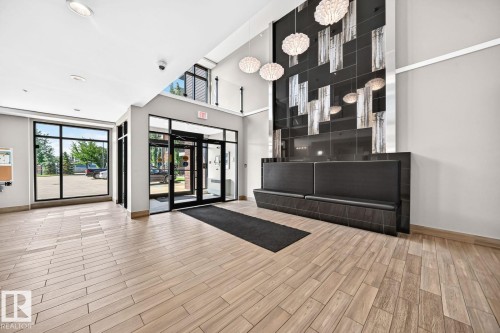Wood-finish tile flooring throughout the space - #238 1008 Rosenthal Bv Nw, Edmonton, AB - Indoor Photo Showing Other Room
