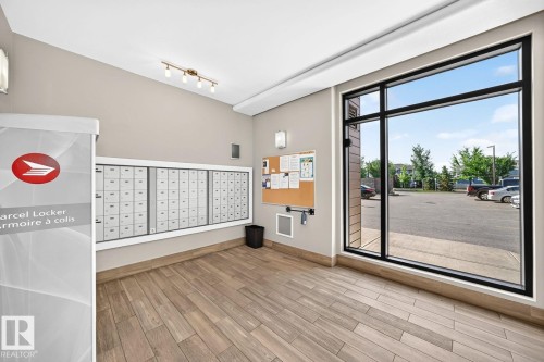 Wall-mounted mailboxes, parcel locker, and bulletin board - #238 1008 Rosenthal Bv Nw, Edmonton, AB - Indoor Photo Showing Other Room