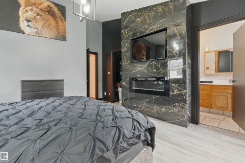 9716 160 Street Nw, Edmonton, AB - Indoor Photo Showing Bedroom With Fireplace