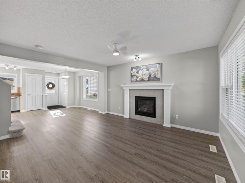 7835 Schmid Place Nw, Edmonton, AB - Indoor Photo Showing Living Room With Fireplace