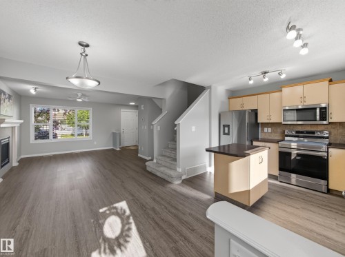 7835 Schmid Place Nw, Edmonton, AB - Indoor Photo Showing Kitchen With Fireplace