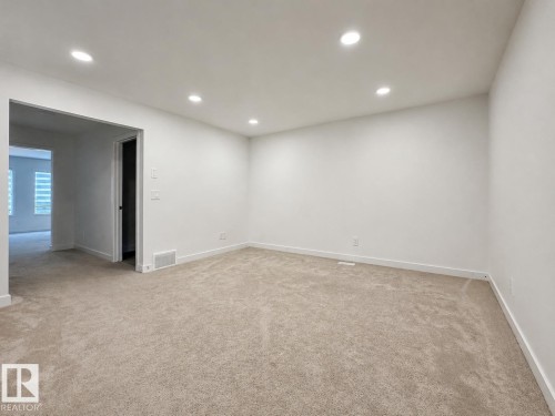 Spacious room with recessed lighting, light-toned carpeting, white walls, and white baseboards - 5478 Kootook Road Sw, Edmonton, AB - Indoor Photo Showing Other Room