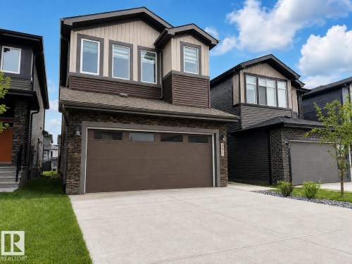 Contemporary two-story residence featuring a two-car garage with a brown door - 5478 Kootook Road Sw, Edmonton, AB - Outdoor
