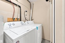 Dedicated laundry area with utility hookups and neutral wall finishes - 