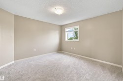 Neutral-toned room featuring a single window and recessed lighting - 