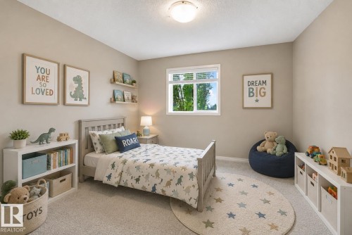 Neutral-toned room featuring a single window with blinds, carpeted flooring, and a flush-mount ceiling light fixture - #144 104 West Haven Dr, Leduc, AB - Indoor Photo Showing Bedroom