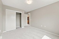 Neutral-toned walls complement plush carpeting throughout this room - 