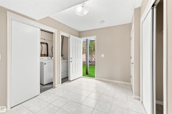 Utility space featuring white square floor tiles and neutral wall paint - 