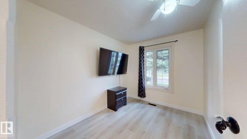 Room featuring neutral wall tones, wood-finish flooring, and a ceiling fan with integrated lighting - 12812 45 Street Nw, Edmonton, AB - Indoor Photo Showing Other Room