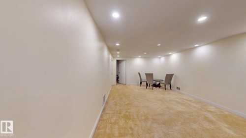 Spacious room featuring neutral wall tones, recessed ceiling lighting, and light-toned carpet flooring - 12812 45 Street Nw, Edmonton, AB - Indoor Photo Showing Other Room