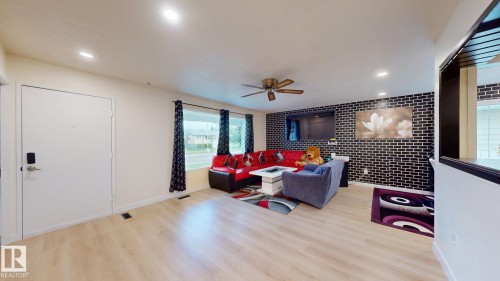 Open concept living area with light wood-finish flooring - 12812 45 Street Nw, Edmonton, AB - Indoor Photo Showing Other Room