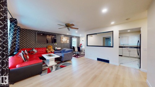 Open-concept living space featuring wood-finish flooring, recessed lighting, and a ceiling fan - 12812 45 Street Nw, Edmonton, AB - Indoor