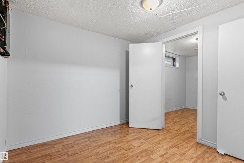 Wood-finish flooring with white walls and a white ceiling - #9 14230 80 St Nw, Edmonton, AB - Indoor Photo Showing Other Room
