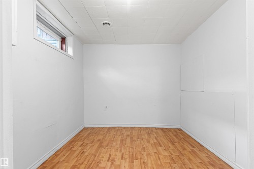 Wood-finish flooring with white walls - #9 14230 80 St Nw, Edmonton, AB - Indoor Photo Showing Other Room