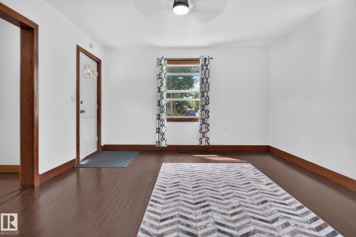White interior walls with contrasting dark wood-finish flooring - 9921 109 Street, Fort Saskatchewan, AB - Indoor