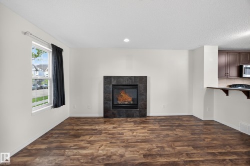 3634 12 Street Nw, Edmonton, AB - Indoor Photo Showing Living Room With Fireplace