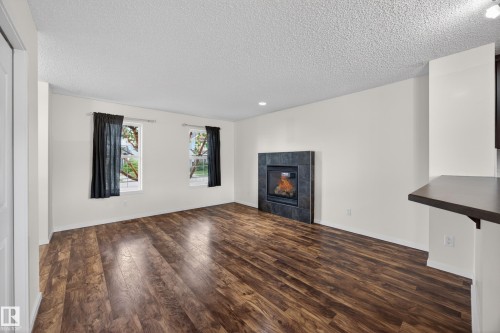 3634 12 Street Nw, Edmonton, AB - Indoor Photo Showing Living Room With Fireplace