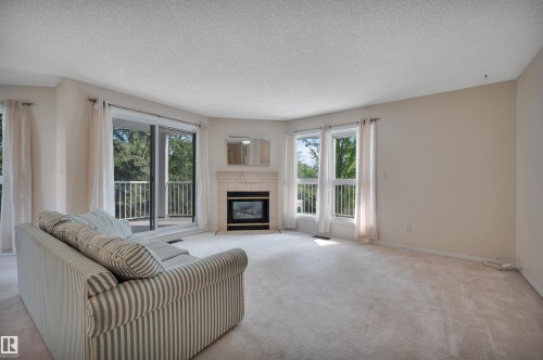 #209 65 Gervais Rd, St. Albert, AB - Indoor Photo Showing Living Room With Fireplace