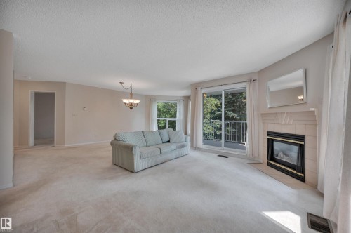 #209 65 Gervais Rd, St. Albert, AB - Indoor Photo Showing Living Room With Fireplace