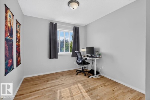 Hardwood flooring, painted walls, white trim, and a flush mount ceiling light - 722 88A Street Sw, Edmonton, AB - Indoor Photo Showing Office
