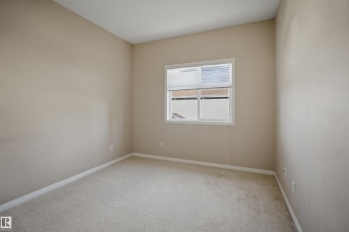 Neutral-toned wall finishes throughout - #95 3040 Spence Wd Sw, Edmonton, AB - Indoor Photo Showing Other Room