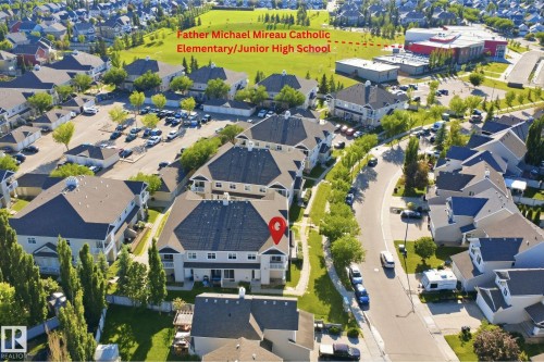 Aerial view showcasing a residential community with abundant green spaces and tree-lined streets - #95 3040 Spence Wd Sw, Edmonton, AB - Outdoor With View