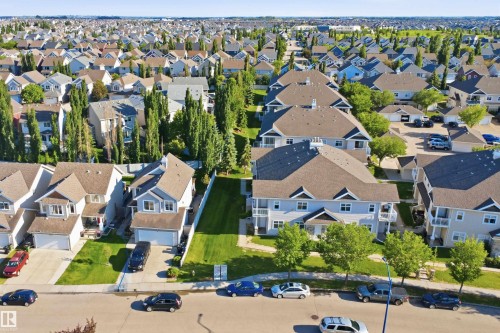 Residential street featuring single-family homes and multi-unit dwellings - #95 3040 Spence Wd Sw, Edmonton, AB - Outdoor With View