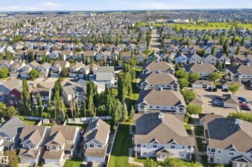 Residential properties featuring mature landscaping, consistent architectural styles, and well-maintained roadways - #95 3040 Spence Wd Sw, Edmonton, AB - Outdoor With View