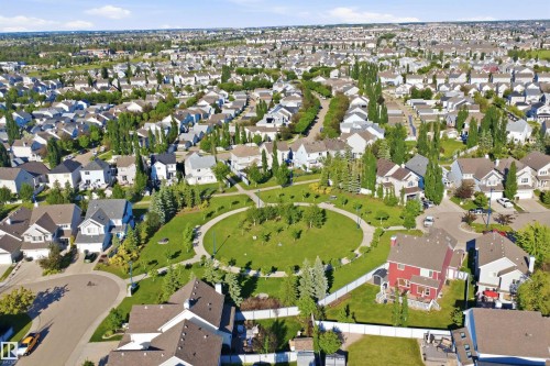 Aerial view showcasing a residential development with a central circular green space - #95 3040 Spence Wd Sw, Edmonton, AB - Outdoor With View