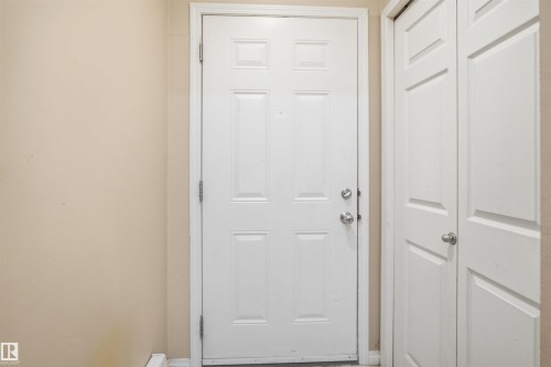 White paneled door with brushed nickel hardware - #95 3040 Spence Wd Sw, Edmonton, AB - Indoor Photo Showing Other Room