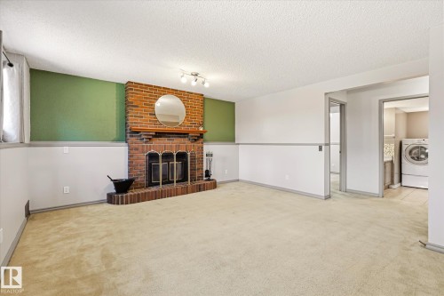 7704 152B Avenue Nw, Edmonton, AB - Indoor Photo Showing Living Room With Fireplace