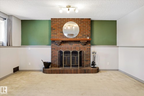 7704 152B Avenue Nw, Edmonton, AB - Indoor Photo Showing Living Room With Fireplace