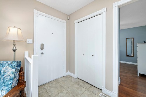 Welcoming entryway showcasing ceramic tile flooring, white panel doors with brushed nickel hardware, neutral wall finishes, and recessed ceiling lighting - 3511 73 Street Nw, Edmonton, AB 