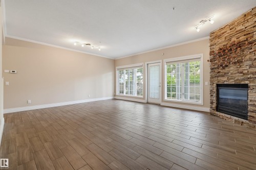 #108 11650 79 Av Nw, Edmonton, AB - Indoor Photo Showing Living Room With Fireplace