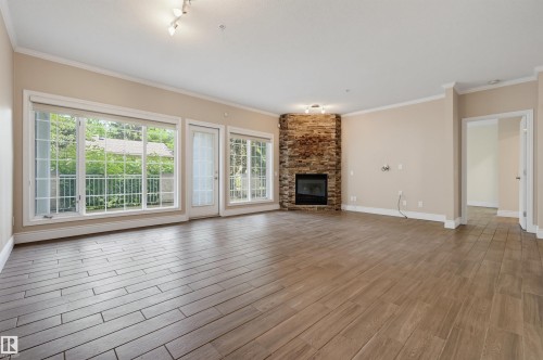 #108 11650 79 Av Nw, Edmonton, AB - Indoor Photo Showing Living Room With Fireplace