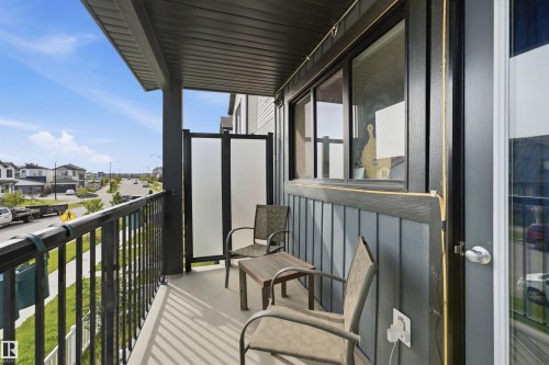 Private balcony featuring a metal railing, durable exterior siding, and a partial privacy screen - 1172 Aster Boulevard Nw Nw, Edmonton, AB - Outdoor With Balcony With Exterior
