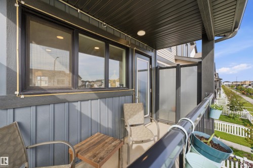 Covered exterior balcony featuring a dark gray railing and privacy panels - 1172 Aster Boulevard Nw Nw, Edmonton, AB - Outdoor With Exterior
