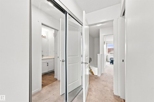 Corridor with neutral carpet flooring and white painted walls - 1172 Aster Boulevard Nw Nw, Edmonton, AB - Indoor Photo Showing Other Room