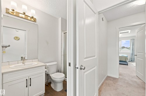 Bathroom with a white vanity, undermount sink, and quartz-finish countertop - 1172 Aster Boulevard Nw Nw, Edmonton, AB - Indoor Photo Showing Bathroom