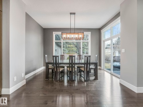 Wood-finish flooring with crisp white trim - 8927 120 Street Nw, Edmonton, AB - Indoor Photo Showing Dining Room