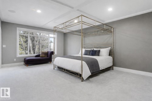 Recessed lighting, crown molding, tray ceiling, large picture windows, and light-toned carpeting - 8927 120 Street Nw, Edmonton, AB - Indoor Photo Showing Bedroom