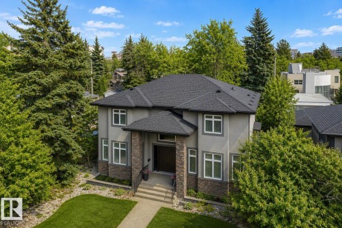 Gray stucco exterior with dark shingle roofing - 8927 120 Street Nw, Edmonton, AB - Outdoor